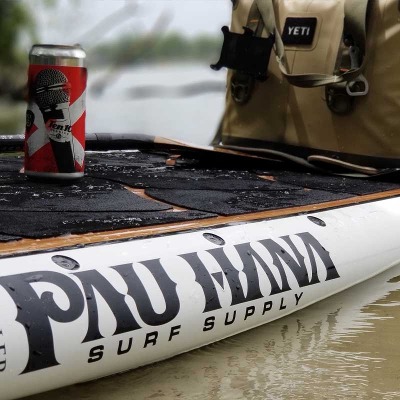 a beer and a cool bag on the big ez angler paddleboard floating on the water