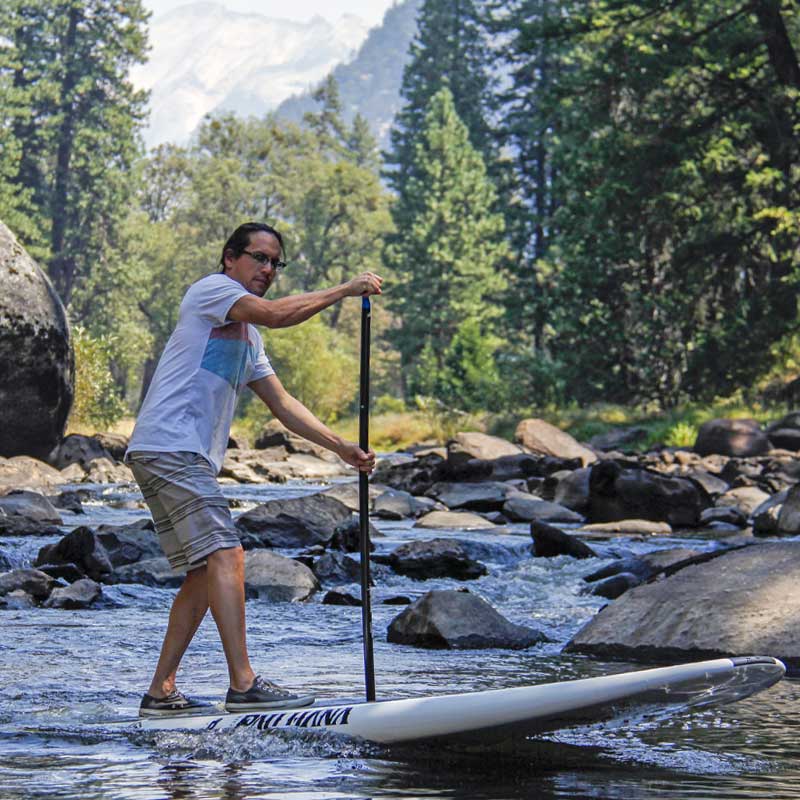 Paddleboarding on a rocky river in Yosemite