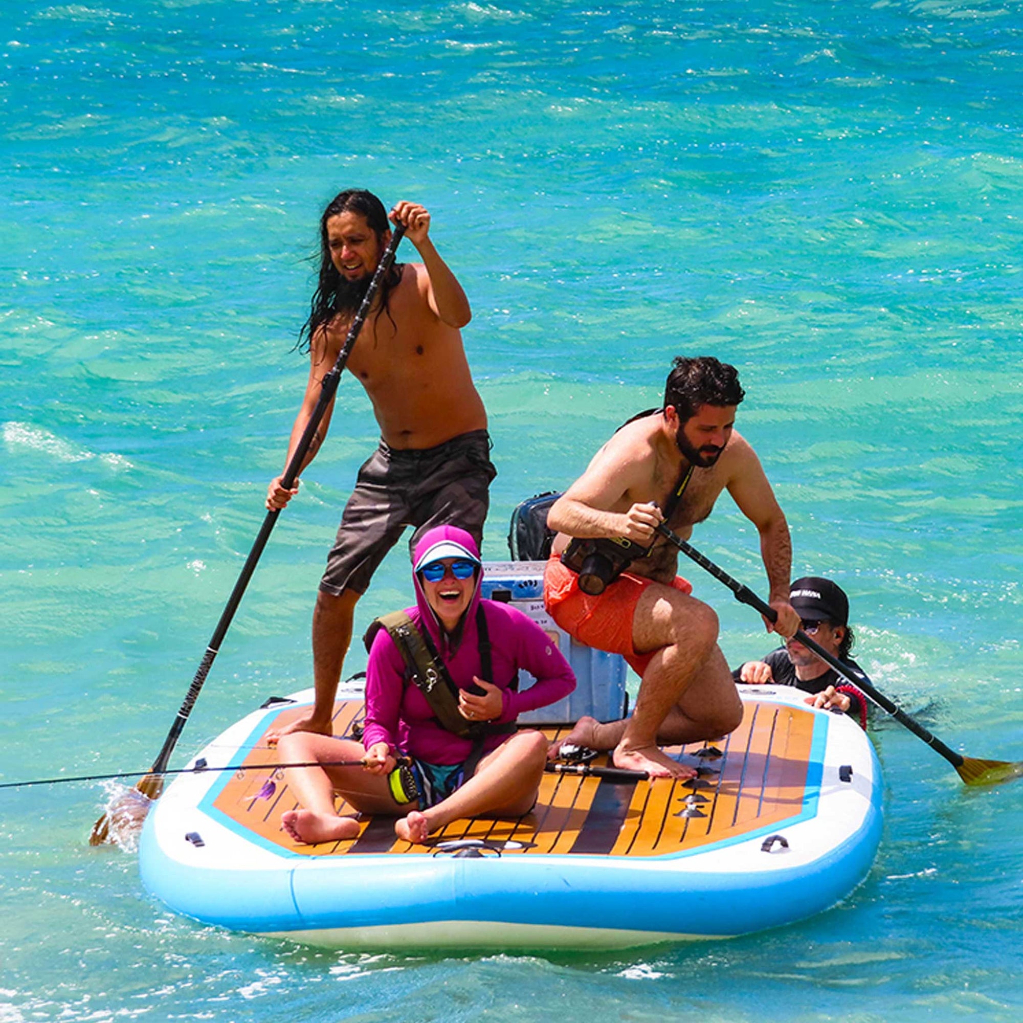 a group of people having fun on a giant inflatable paddleboard on the sea