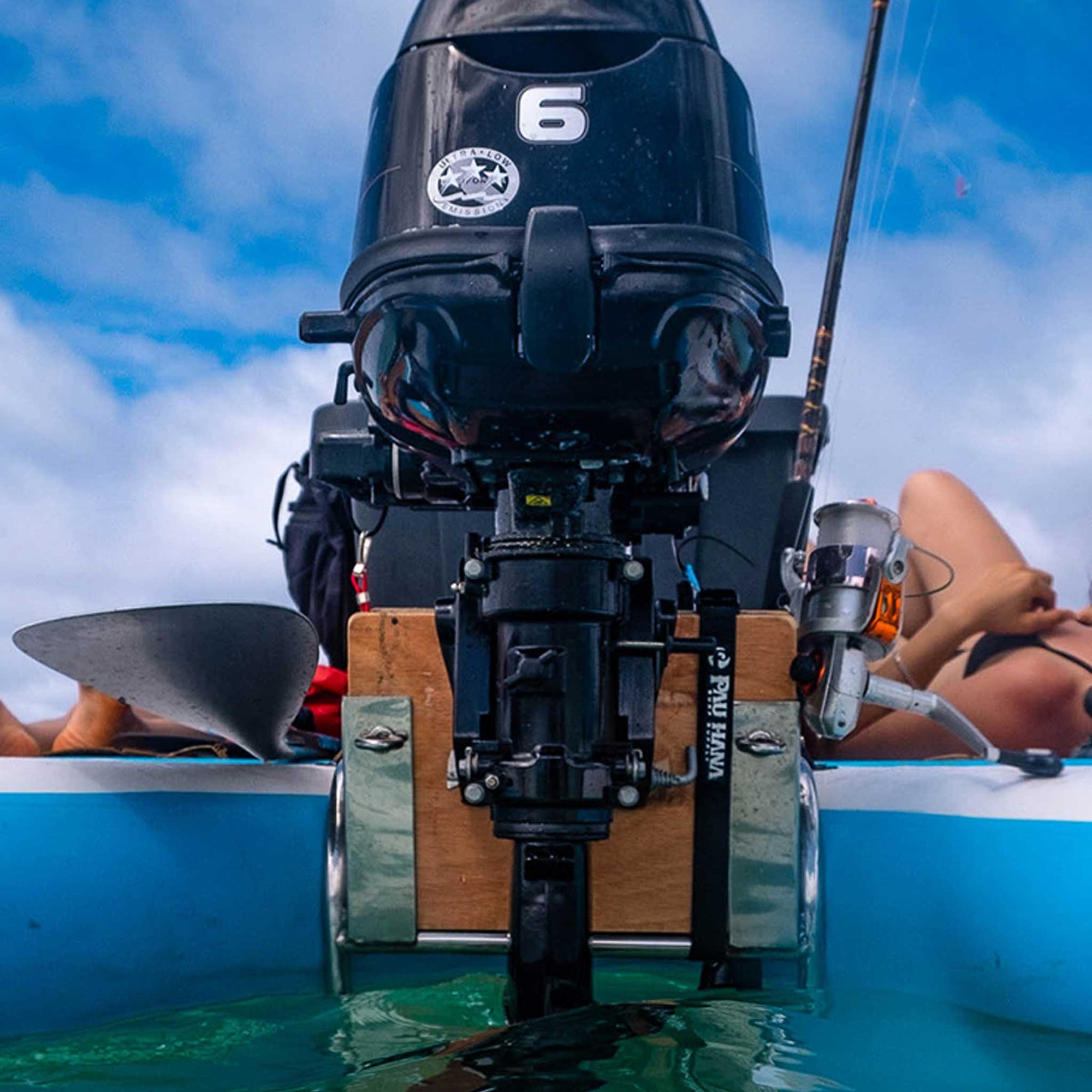 a four stroke engine attached to the back of a giant inflatable paddleboard