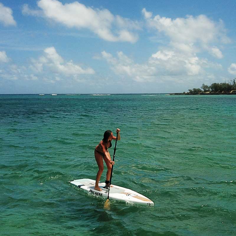 A girl paddleboarding on the ocean