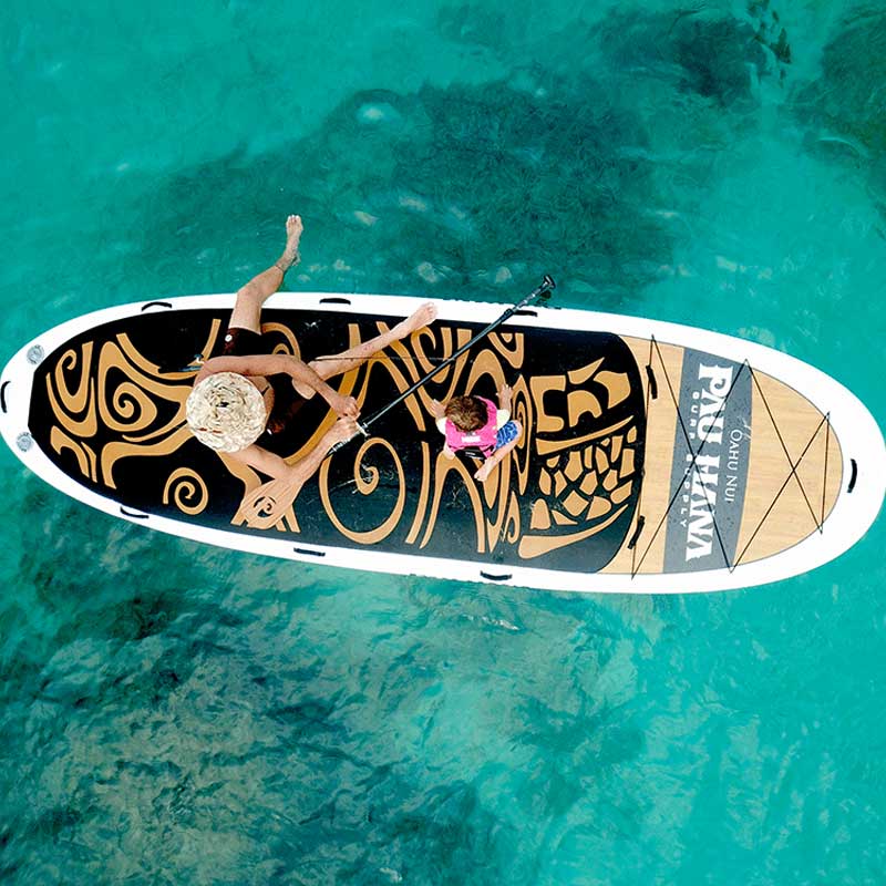 an aerial image of a farther and child on the oahu nui inflatable paddleboard 