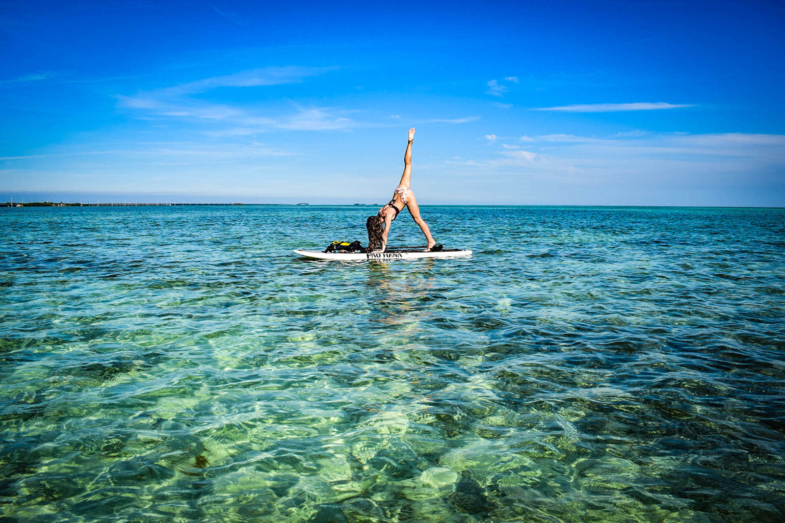 Doing yoga on a paddleboard in the middle of the ocean