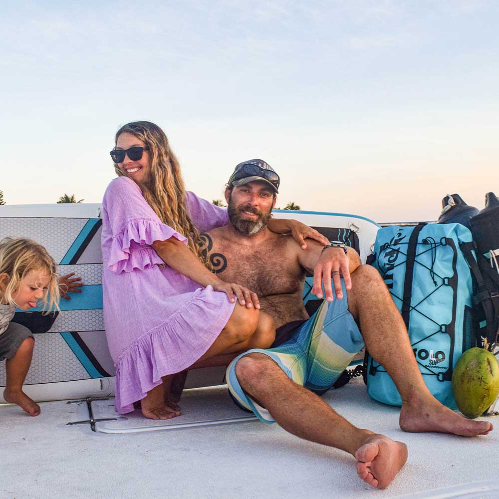 family sittingon a yacht with the solo sup paddleboard in the background