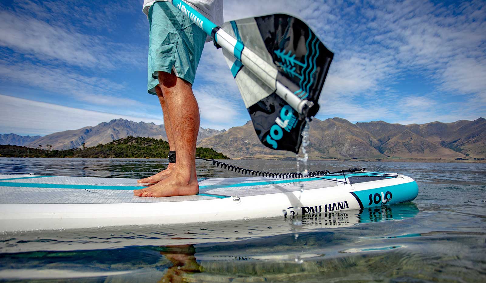 paddling the solo sup backcountry paddleboard on a lake in new zealand